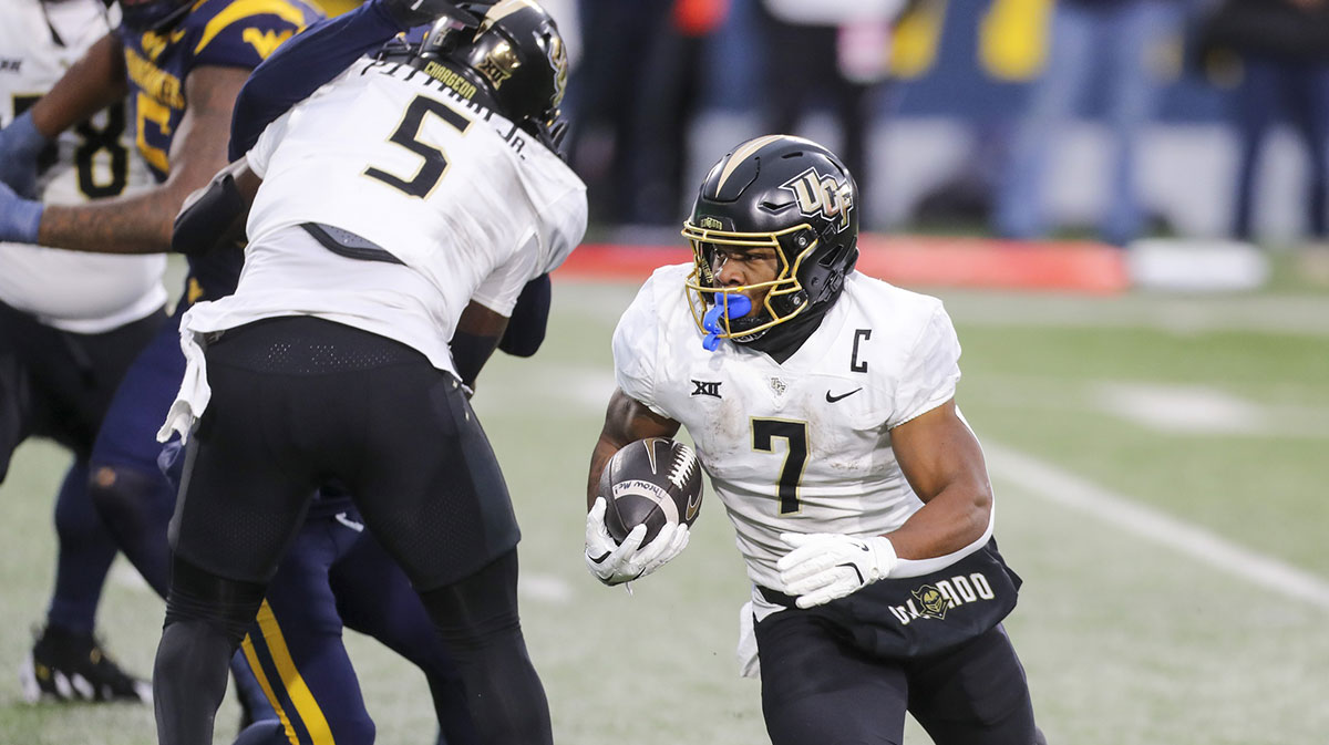 UCF Knights running back RJ Harvey (7) runs the ball for a touchdown against the West Virginia Mountaineers during the second quarter at Mountaineer Field at Milan Puskar Stadium.