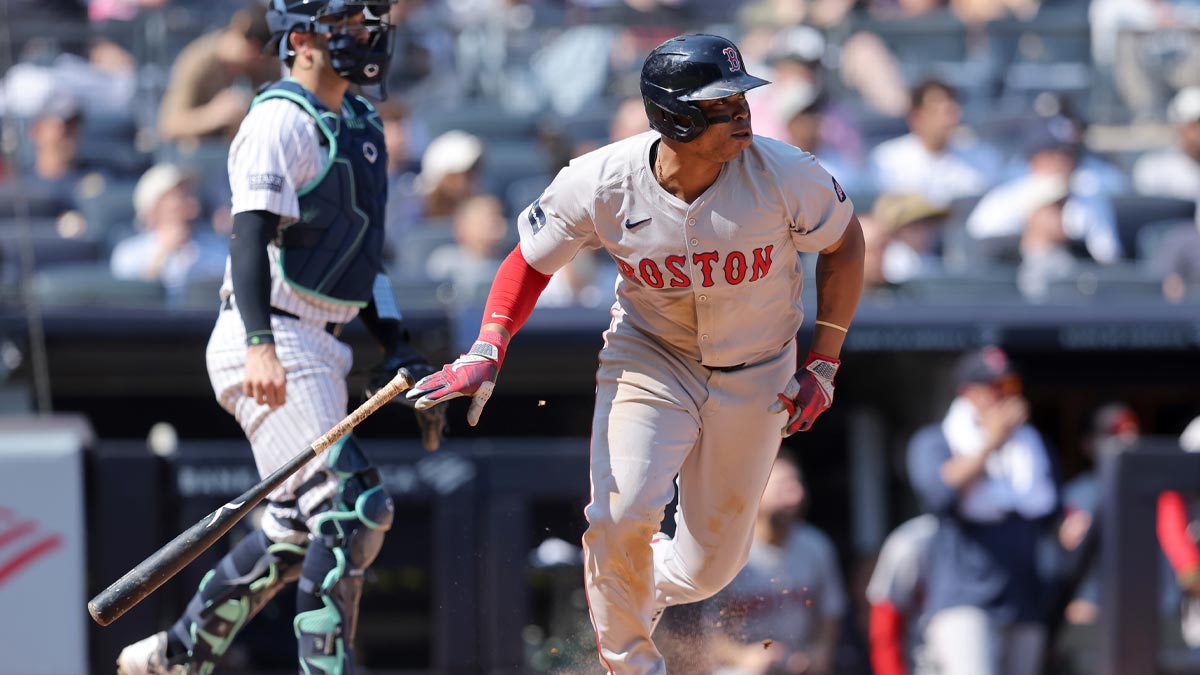 Boston Red Sox third baseman Rafael Devers (11) follows through on a two run single against the New York Yankees during the fifth inning at Yankee Stadium.