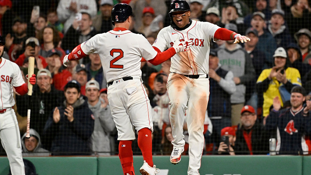 Boston Red Sox third baseman Alex Bregman (2) celebrates a three run home run against the St. Louis Cardinals with designated hitter Rafael Devers (11) during the third inning at Fenway Park.