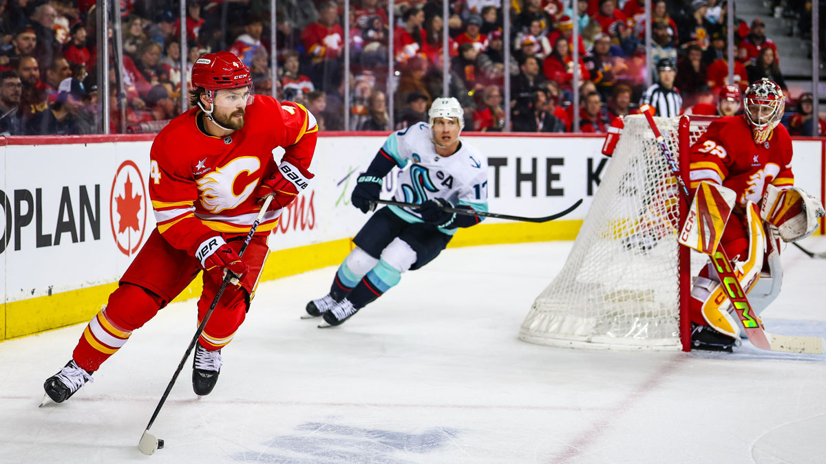 Calgary Flames defenseman Rasmus Andersson (4) controls the puck against the Seattle Kraken during the third period at Scotiabank Saddledome.