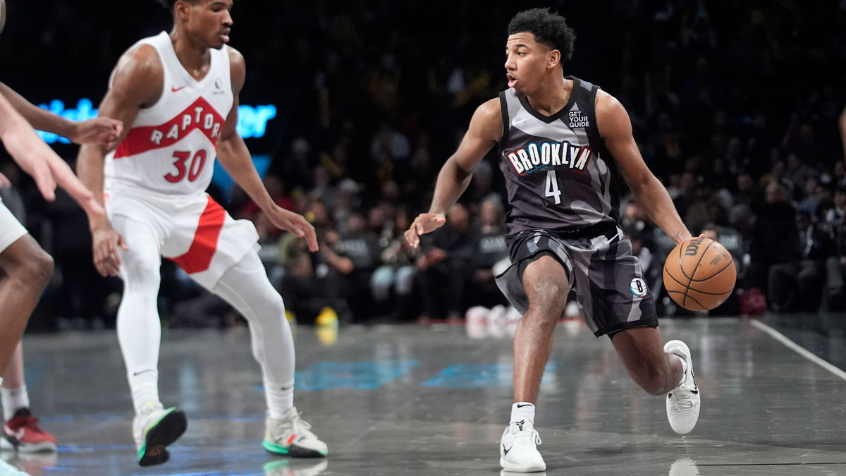 Brooklyn Nets guard Reece Beekman (4) dribbles the ball against Toronto Raptors guard Ochai Agbaji (30) during the second half at Barclays Center.