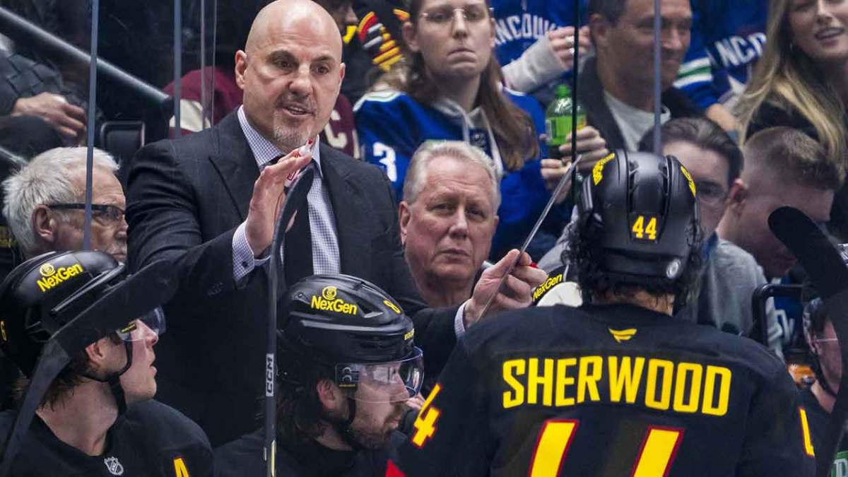 Vancouver Canucks head coach Rick Tocchet talks with forward Kiefer Sherwood (44) on the bench against the Minnesota Wild in the third period at Rogers Arena.