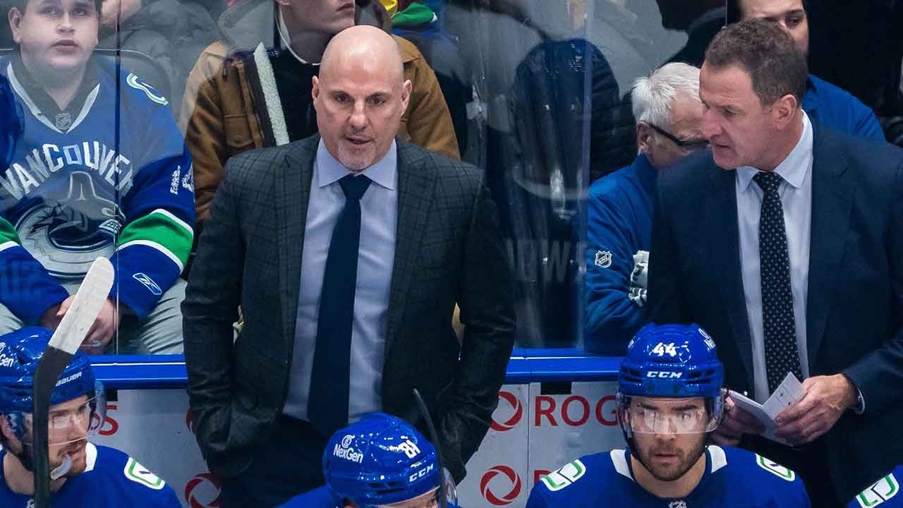 Vancouver Canucks forward Pius Suter (24) and forward Dakota Joshua (81) and forward Kiefer Sherwood (44) and Vancouver Canucks head coach Rick Tocchet and assistant coach Adam Foote on the bench in the first period at Rogers Arena.