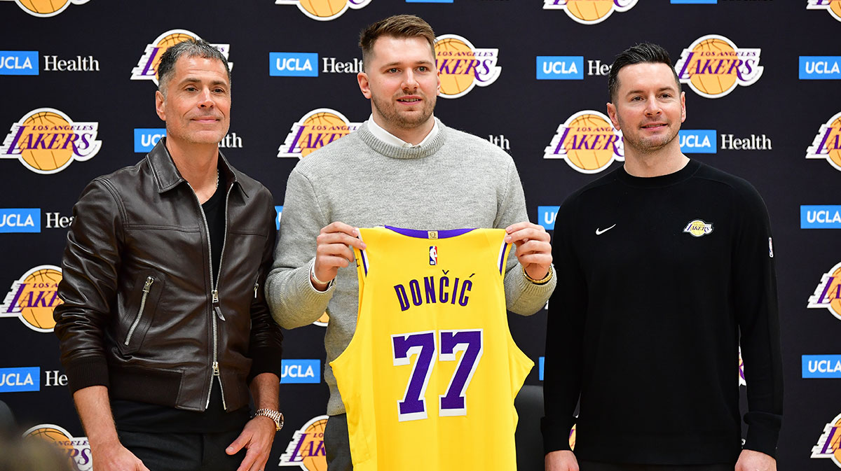 Los Angeles Lakers guard Luka Doncic poses for photos with general manager Rob Pelinka and head coach JJ Redick at UCLA Health Training Center.