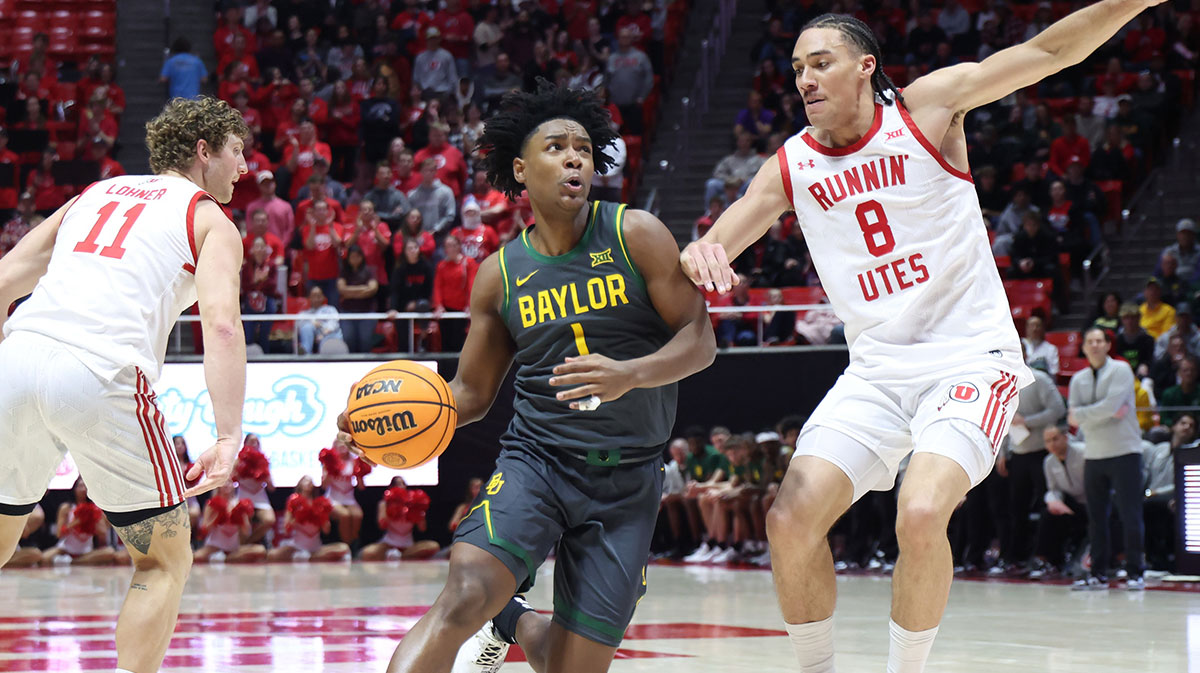 Baylor Bears guard Robert Wright III (1) drives to the basket against Utah Utes forward Keanu Dawes (8) during the first half at Jon M. Huntsman Center. Mandatory Credit: Rob Gray-Imagn Images