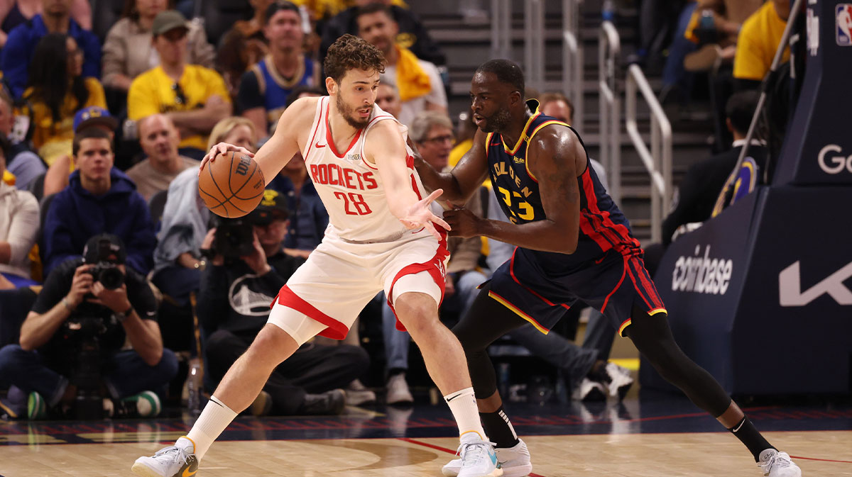 Rockets' Alperen Sengun (28) controls the ball against Warriors' Draymond Green (23)