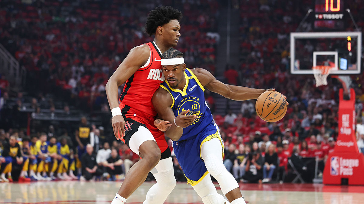 Golden State Warriors forward Jimmy Butler III (10) dribbles the ball as Houston Rockets forward Amen Thompson (1) defends during the first quarter at Toyota Center.