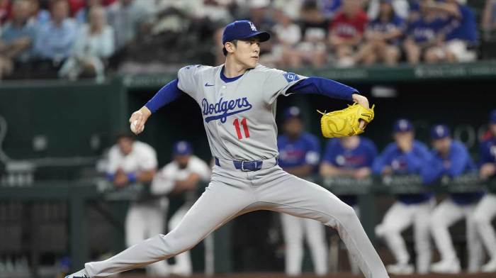 Los Angeles Dodgers starting pitcher Roki Sasaki (11) delivers a pitch to the Texas Rangers during the first inning at Globe Life Field.
