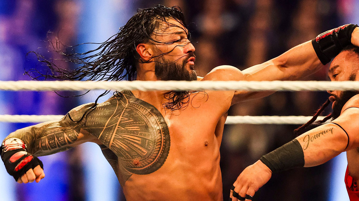 WWE Roman Reigns, who pushed back against critics of his part-time schedule, punching Jacob Fatu.