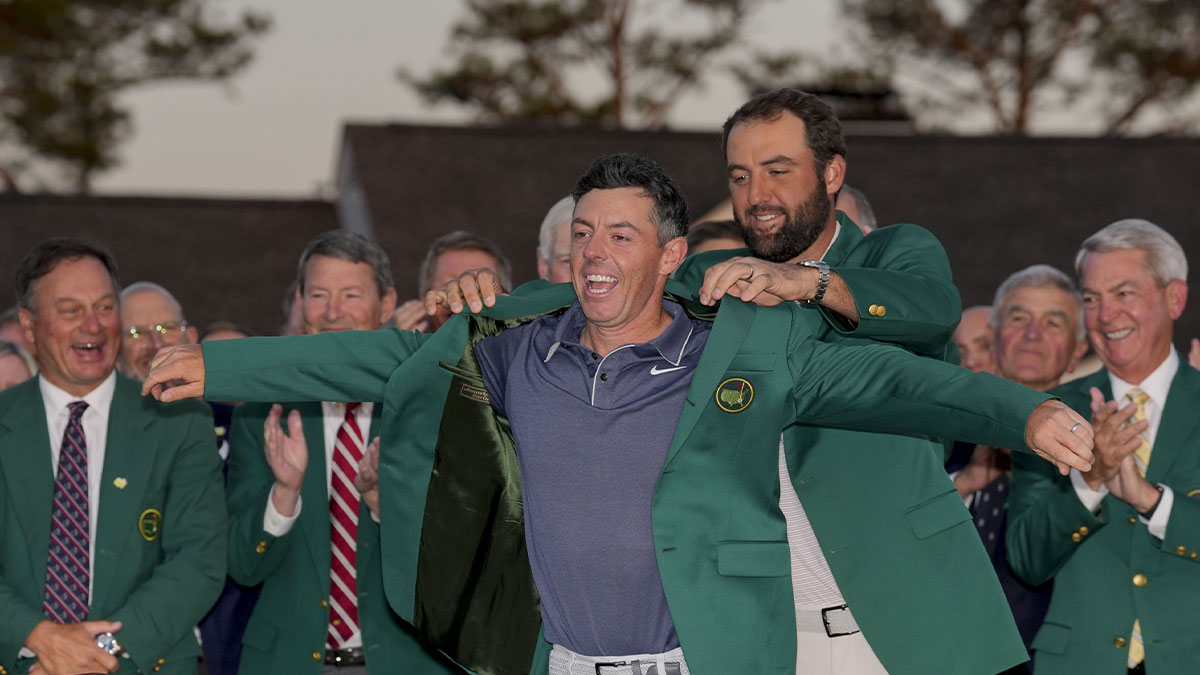 Scottie Scheffler places the green jacket on Rory McIlroy during the green jacket ceremony during the final round of the Masters Tournament at Augusta National Golf Club.