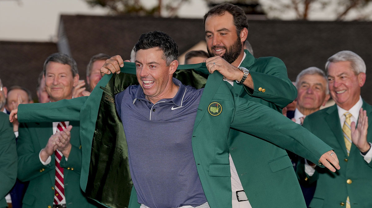 Scottie Scheffler places the green jacket on Rory McIlroy during the green jacket ceremony during the final round of the Masters Tournament at Augusta National Golf Club.