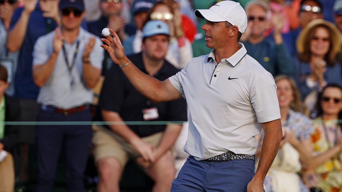 Rory McIlroy waves to the patrons after his putt on the 18th green during the third round of the Masters Tournament at Augusta National Golf Club.