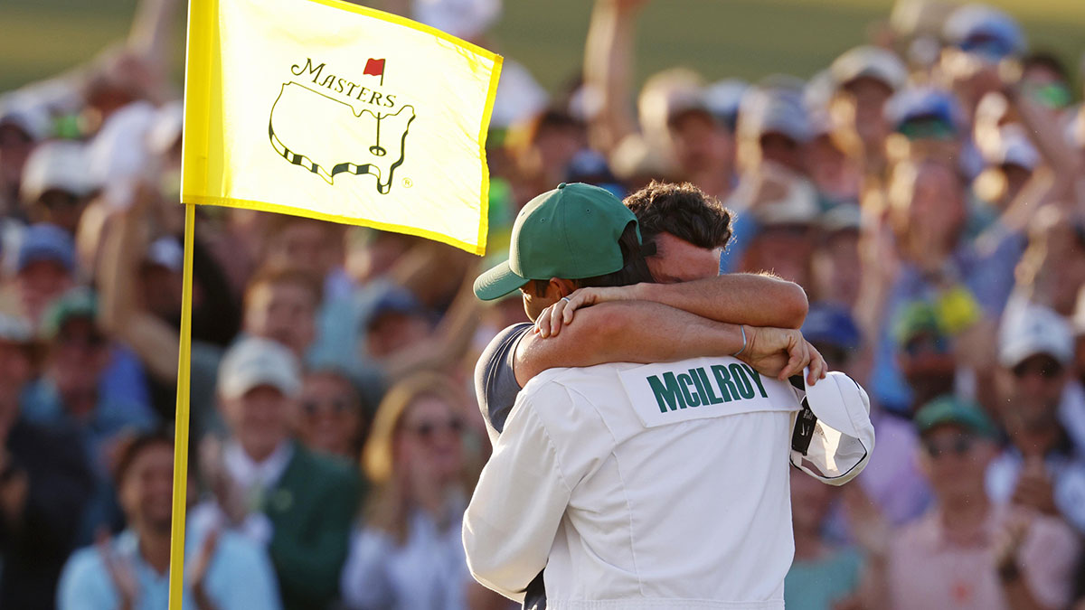 Rory McIlroy celebrates with his caddy, Harry Diamond, after winning in a playoff on the 18th green during the final round of the Masters Tournament at Augusta National Golf Club.