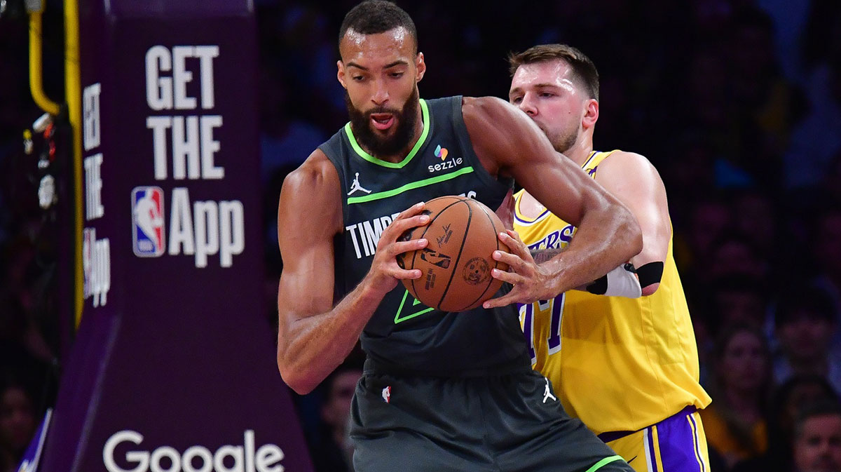 Minnesota Timberwolves center Rudy Gobert (27) gets the ball against Los Angeles Lakers guard Luka Doncic (77) during the first half in game five of first round for the 2025 NBA Playoffs at Crypto.com Arena.