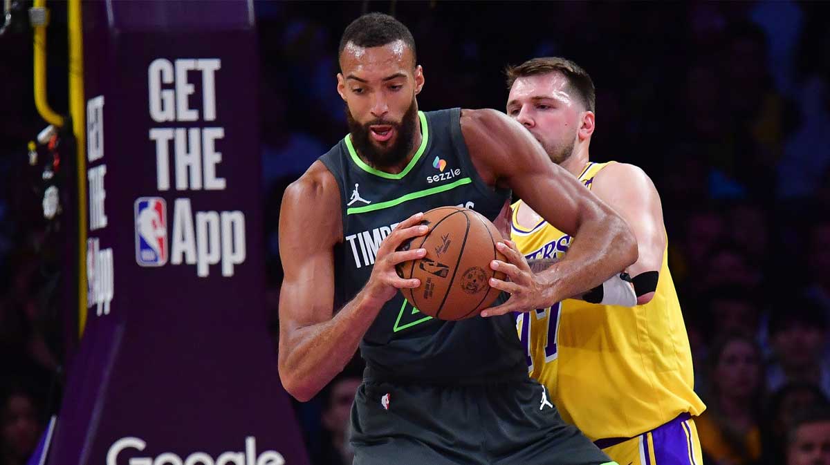 Minnesota Timberwolves center Rudy Gobert (27) gets the ball against Los Angeles Lakers guard Luka Doncic (77) during the first half in game five of first round for the 2025 NBA Playoffs at Crypto.com Arena.