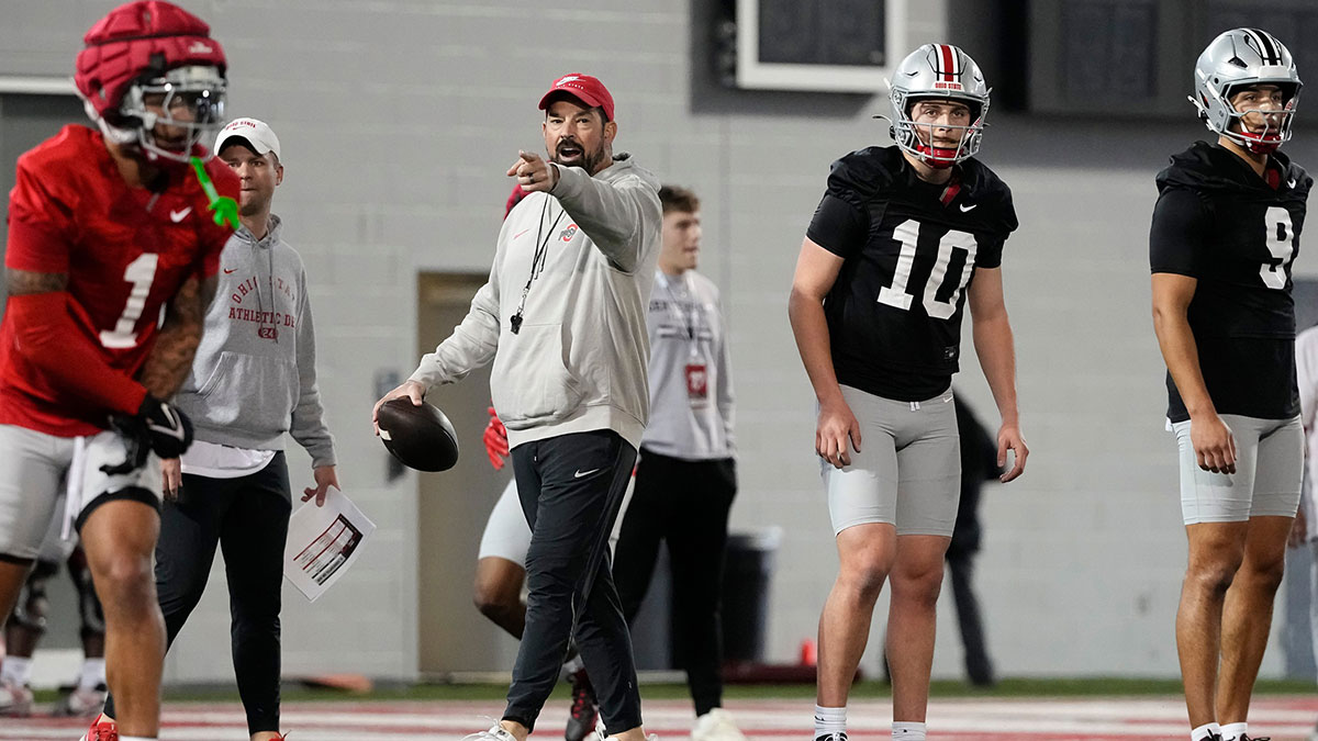 Ohio State Buckeyes head coach Ryan Day works with quarterbacks Julian Sayin (10) and Tavien St. Clair (9) during spring football practice at the Woody Hayes Athletic Center