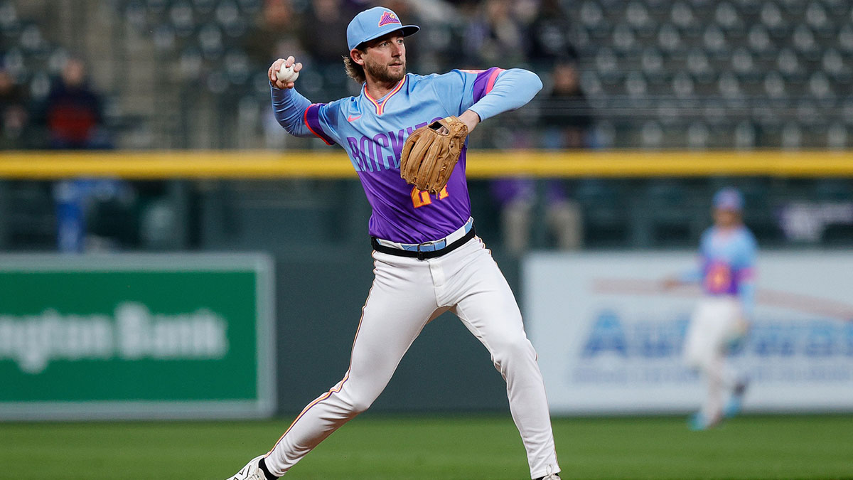 Colorado Rockies third baseman Ryan McMahon (24) fields and throws to first for an out in the first inning against the Cincinnati Reds at Coors Field