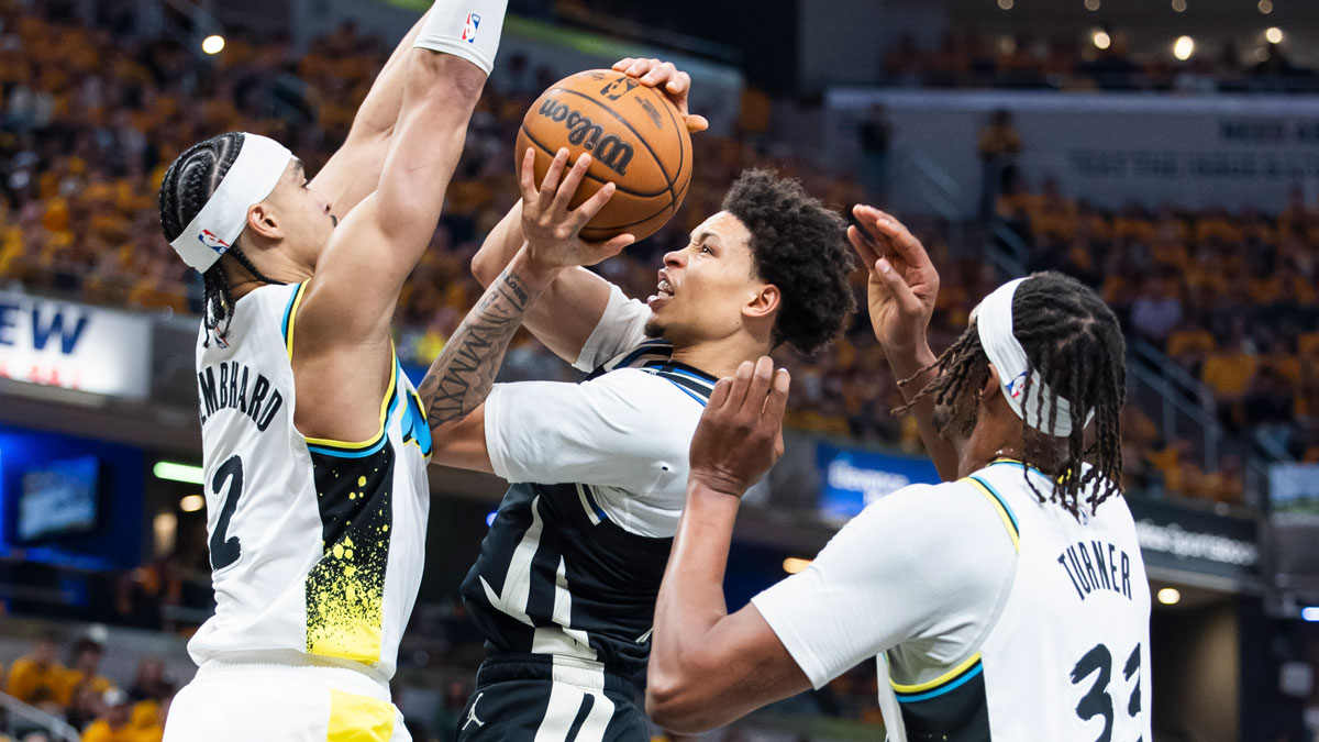 Milwaukee Bucks guard Ryan Rollins (13) shoots the ball while Indiana Pacers guard Andrew Nembhard (2) defends in the first half at Gainbridge Fieldhouse.