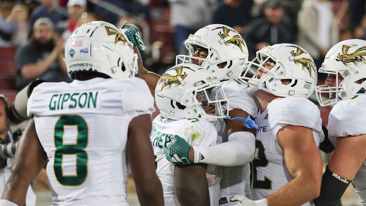 Sacramento State Hornets running back Marcus Fulcher (9) is congratulated by teammates after scoring a touchdown during the fourth quarter against the Stanford Cardinal at Stanford Stadium. Mandatory Credit: Sergio Estrada-Imagn Images