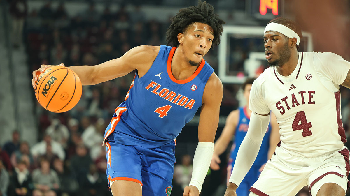Florida Gators forward Sam Alexis (4) drives against Mississippi State Bulldogs forward Cameron Matthews (4) during the first half at Humphrey Coliseum.
