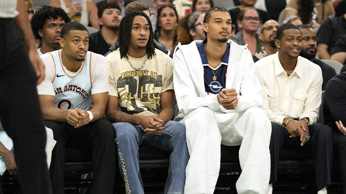San Antonio Spurs (from left to right) forward Keldon Johnson (0), guard Devin Vassell (24), center Victor Wembanyama (1) and guard De'Aron Fox (4) watch the first half of a game against the Toronto Raptors at Frost Bank Center