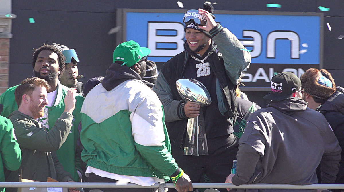 Saquon Barkley, who has been seen with President Donald Trump ahead of the Philadelphia Eagles' White House visit, holding the Lombardi Trophy during the Eagles' Super Bowl 59 parade.
