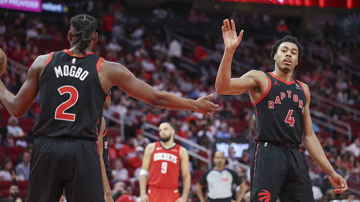 Toronto Raptors forward Scottie Barnes (4) reacts with forward Jonathan Mogbo (2) after a play during the third quarter against the Houston Rockets at Toyota Center.