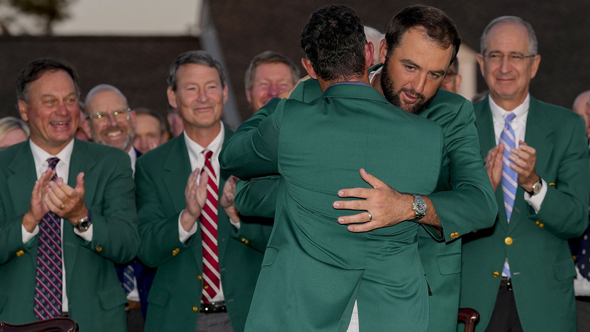 Rory McIlroy hugs Scottie Scheffler at the green jacket ceremony during the final round of the Masters Tournament at Augusta National Golf Club