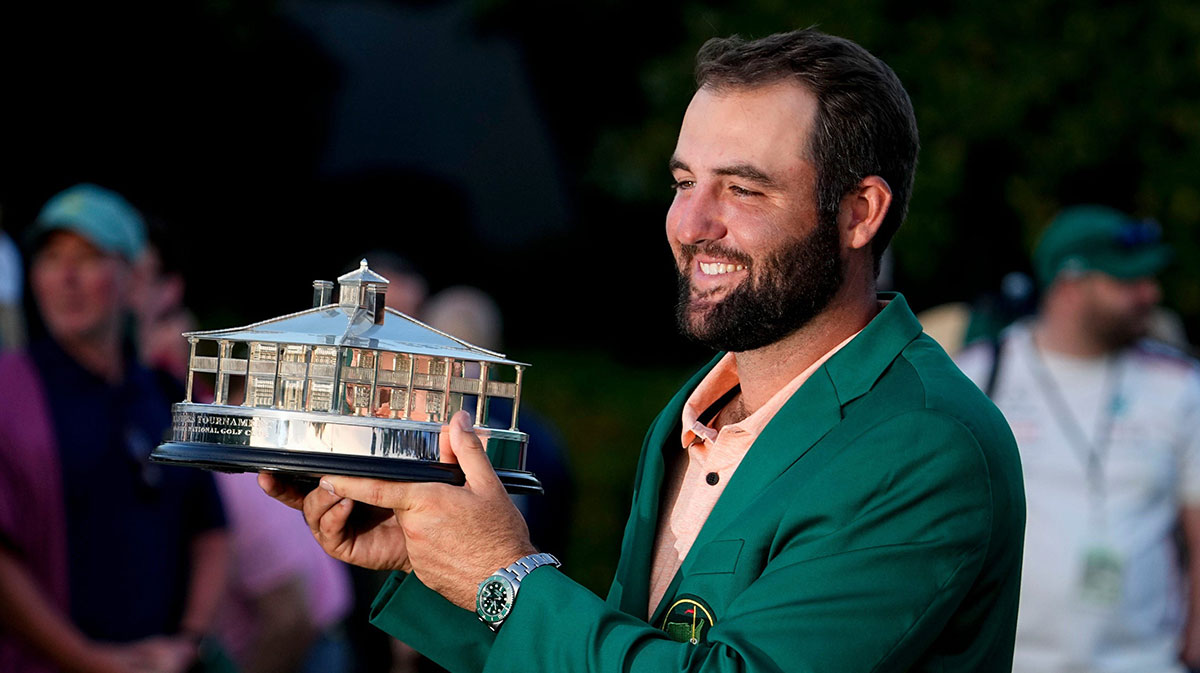 Scottie Scheffler holds up his trophy at the green jacket ceremony after winning the Masters