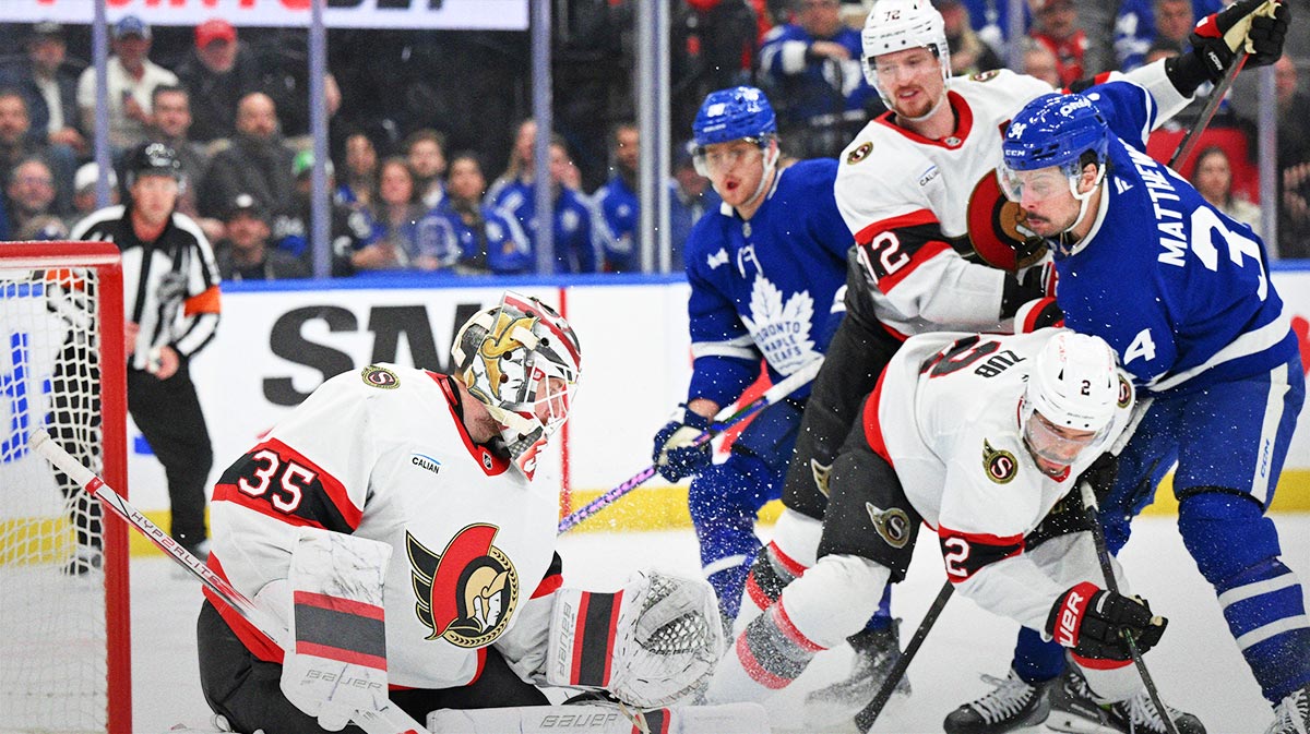 Ottawa Senators goalie Linus Ullmark (35) makes a save as defensemen Artem Zub (2) and Thomas Chabot (72) hold back Toronto Maple Leafs forward Auston Matthews (34) in the third period at Scotiabank Arena