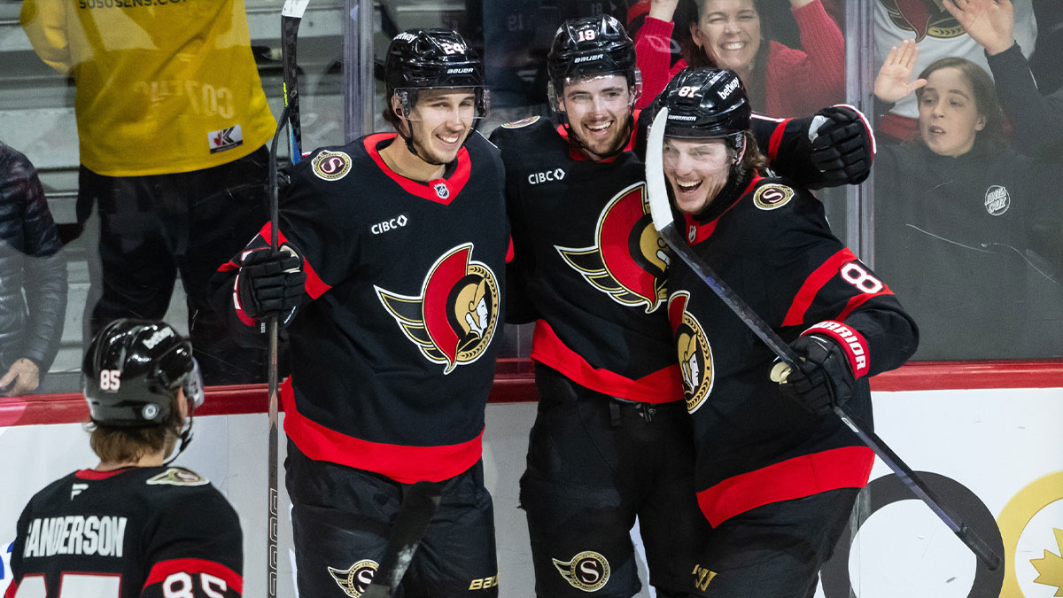 Ottawa Senators right wing Drake Batherson (19) celebrates with defenseman Jake Sanderson (85) and center Dylan Cozens (24) and right wing Adam Gaudette (18) his goal scored in the third period against the Carolina Hurricanes at the Canadian Tire Centre.
