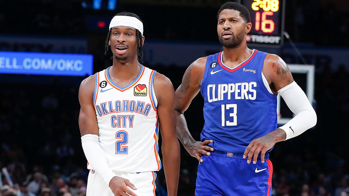 Oklahoma City Thunder guard Shai Gilgeous-Alexander (2) and LA Clippers guard Paul George (13) walks down the court during a time out during the first half at Paycom Center.
