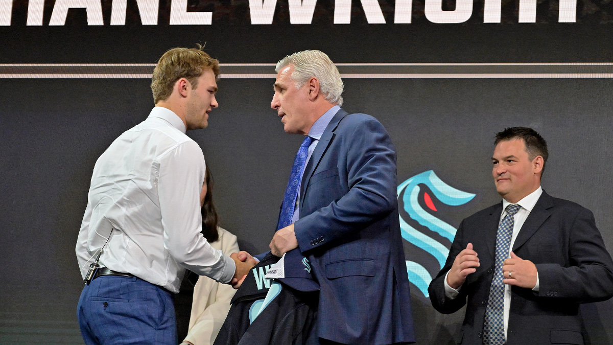 Jul 7, 2022; Montreal, Quebec, CANADA; Shane Wright shakes hands with Seattle Kraken general manager Ron Francis after being selected as the number four overall pick to the Seattle Kraken in the first round of the 2022 NHL Draft at Bell Centre. Mandatory Credit: Eric Bolte-Imagn Images