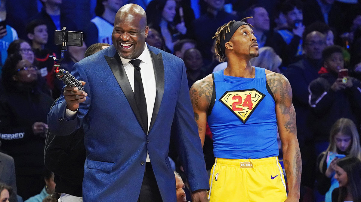 Former NBA player Shaquille O'Neal laughs while standing next to Los Angeles Lakers player Dwight Howard during the slam dunk contest during NBA All Star Saturday Night at United Center.