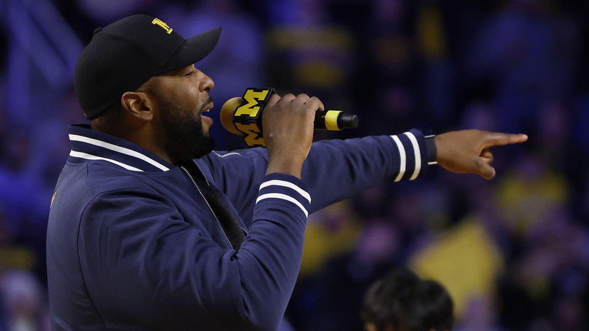 Michigan Wolverines head coach football Sherrone Moore addresses the crowd during a basketball game against the Iowa Hawkeyes at Crisler Center.
