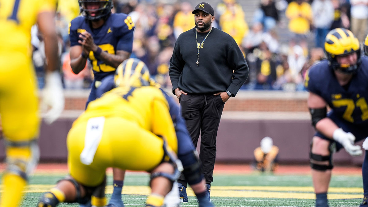 Michigan head coach Sherrone Moore watches a play behind quarterback Bryce Underwood (19) during the second half of the spring game at Michigan Stadium