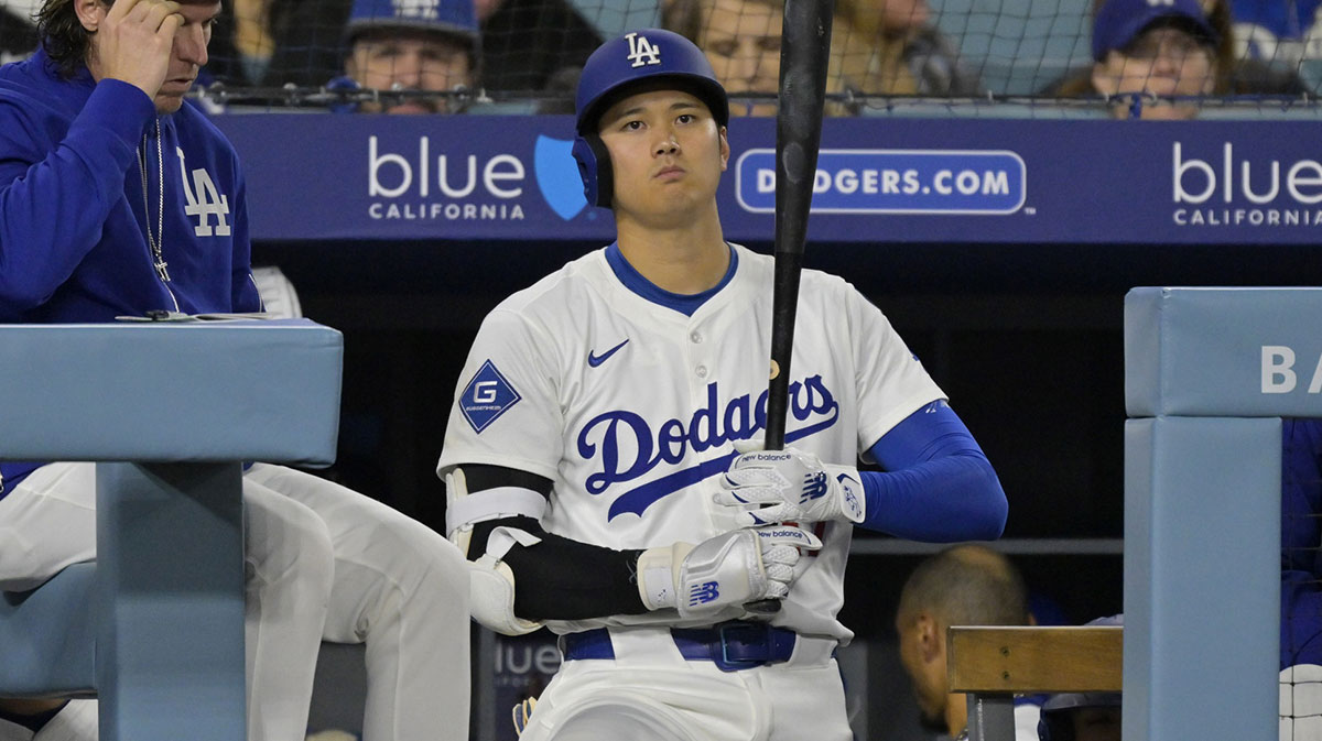 Los Angeles Dodgers designated hitter Shohei Ohtani (17) looks on from the dugout in the third inning against the Colorado Rockies at Dodger Stadium.