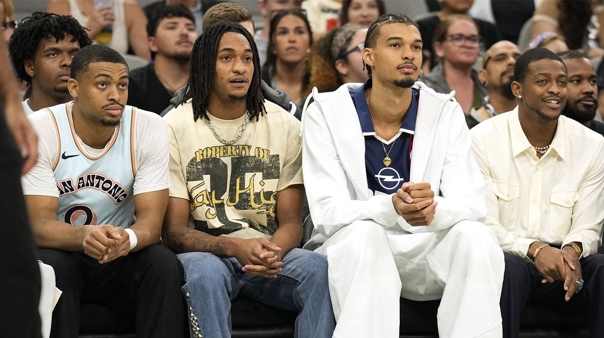 San Antonio Spurs (from left to right) forward Keldon Johnson (0), guard Devin Vassell (24), center Victor Wembanyama (1) and guard De'Aron Fox (4) watch the first half of a game against the Toronto Raptors at Frost Bank Center.