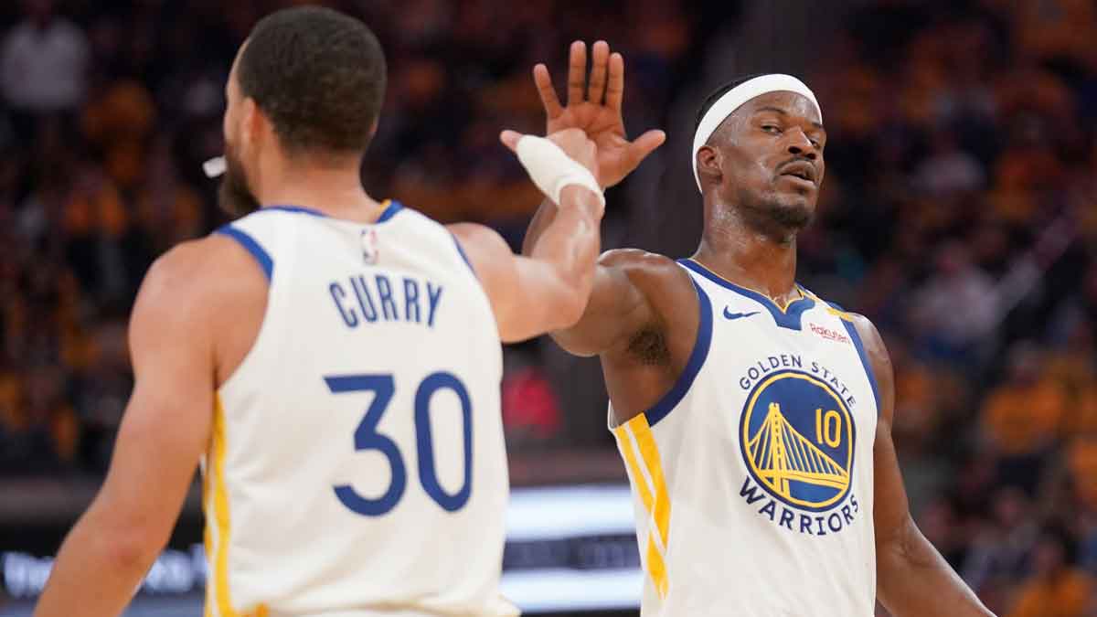 Golden State Warriors forward Jimmy Butler III (10) and guard Stephen Curry (30) meet after a play against the Memphis Grizzlies in the second quarter at the Chase Center.