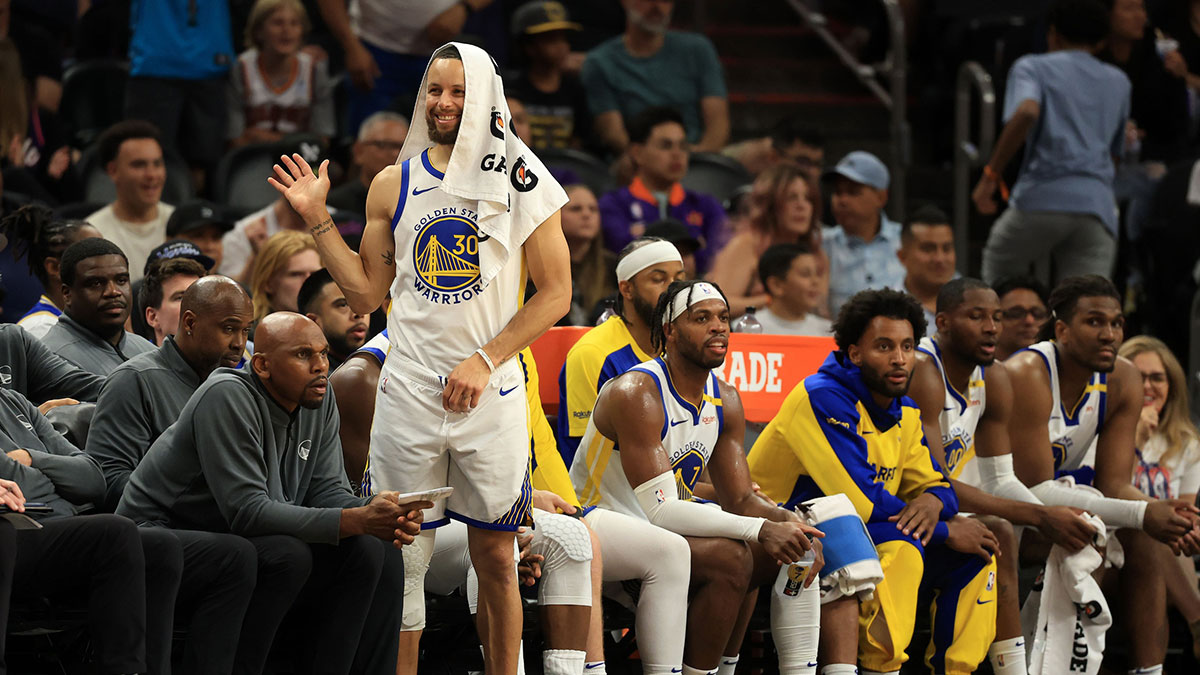 Golden State Warriors guard Stephen Curry (30) reacts on the bench against the Phoenix Suns during the second half at Footprint Center.