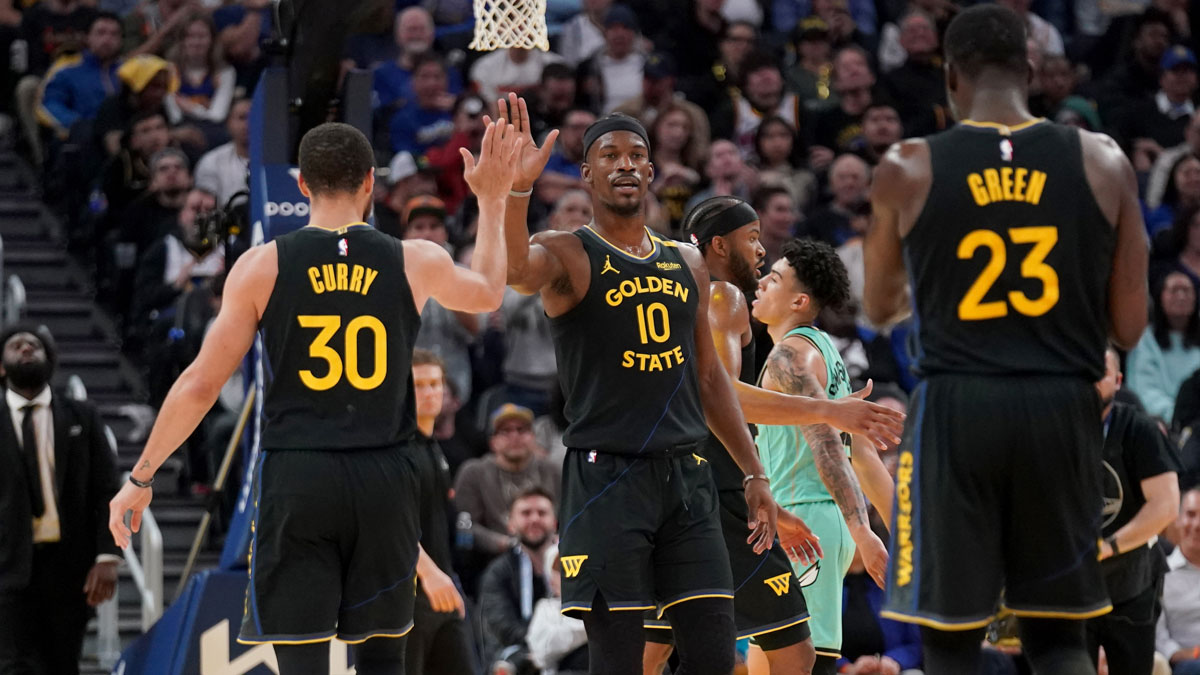 Golden State Warriors forward Jimmy Butler III (10) is congratulated by guard Stephen Curry (30) after a basket against the Charlotte Hornets in the third quarter at the Chase Center.