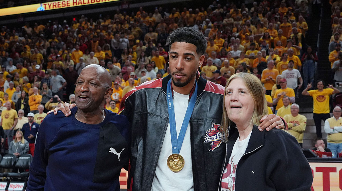 Former Iowa State and Indiana Packer guard Tyrese Haliburton holds his parents John and Brenda Haliburton as the unveiling his Olympic 24 gold made banner during the halftime of Cyclones and Wildcats men’s basketball showdown at Hilton Coliseum on Saturday March 1, 2025 in Ames, Iowa.