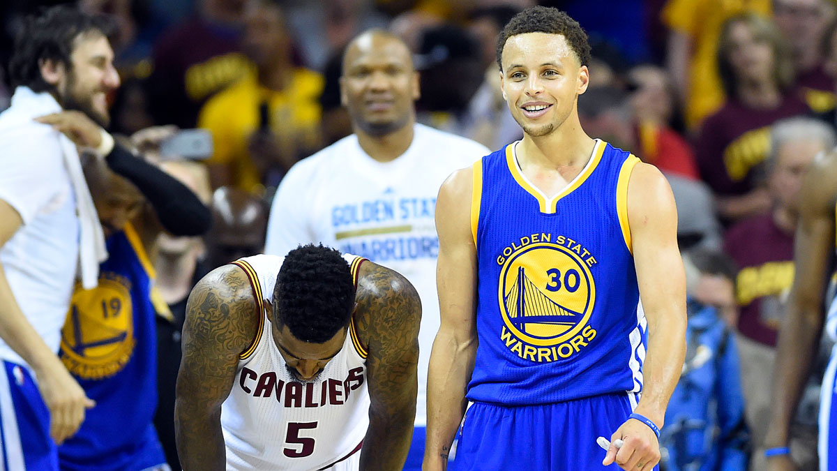 Golden State Warriors guard Stephen Curry (30) reacts next to Cleveland Cavaliers guard J.R. Smith (5) in the closing seconds of game six of the NBA Finals at Quicken Loans Arena.