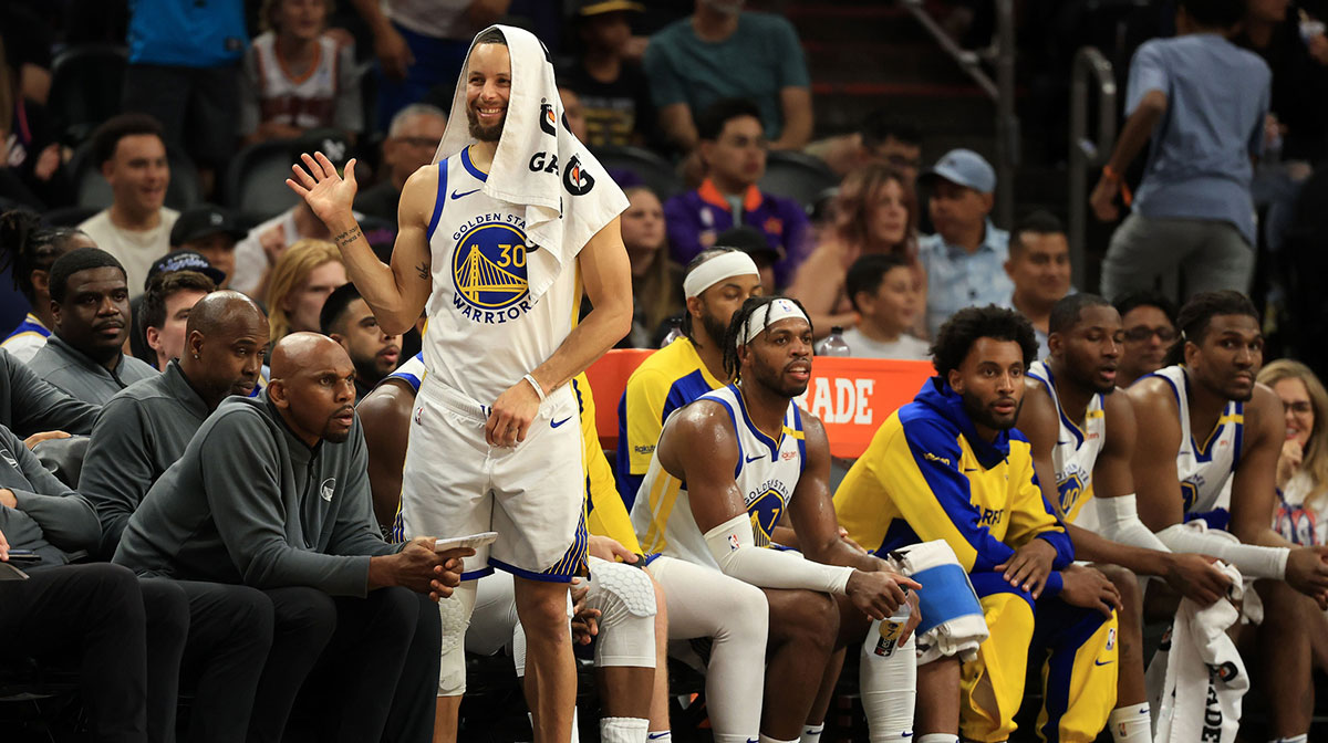 Golden State Warriors guard Stephen Curry (30) reacts on the bench against the Phoenix Suns during the second half at Footprint Center.
