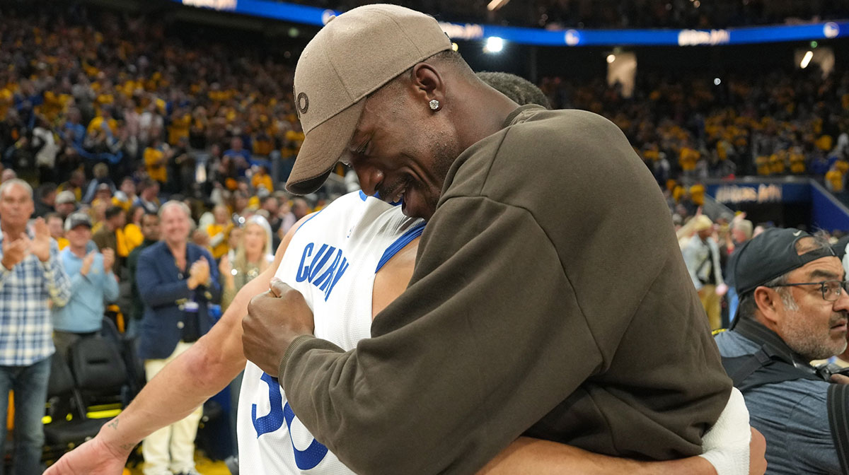 Golden State Warriors guard Stephen Curry (left) and forward Jimmy Butler III (right) hug after defeating the Houston Rockets during game three of first round for the 2024 NBA Playoffs at Chase Center.