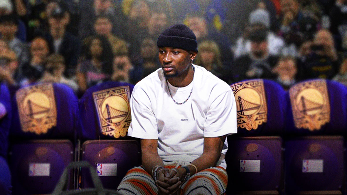 Jonathan Kuminga sitting on the Warriors bench.