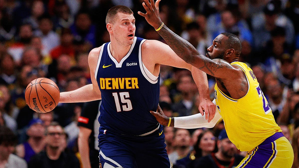 Denver Nuggets center Nikola Jokic (15) controls the ball under pressure from Los Angeles Lakers forward LeBron James (23) in the first quarter during game five of the first round for the 2024 NBA playoffs at Ball Arena.