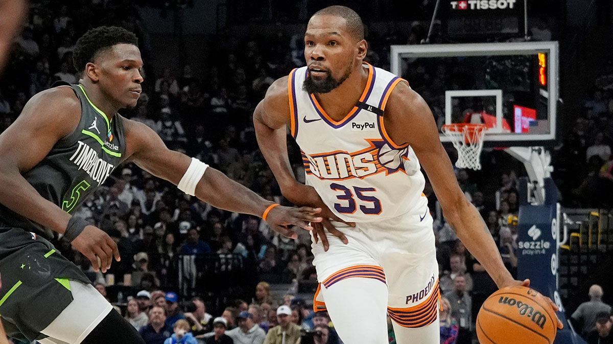 Phoenix Suns forward Kevin Durant (35) brings the ball up as Minnesota Timberwolves guard Anthony Edwards (5) defends him in the fourth quarter at Target Center.