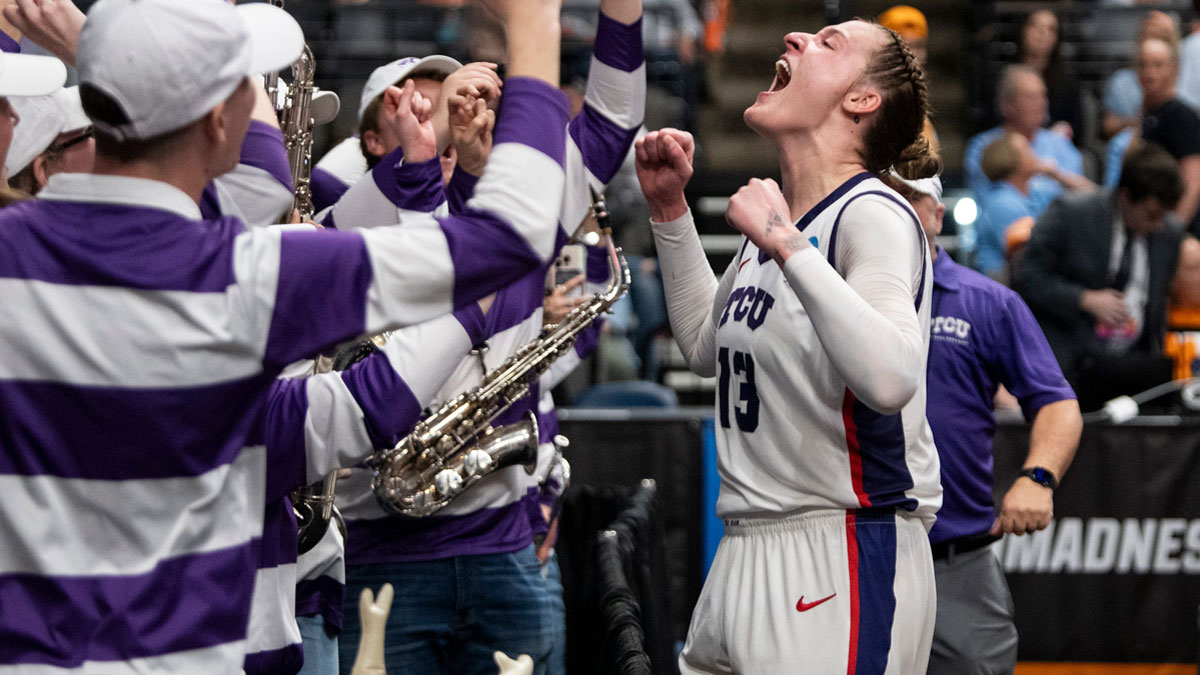 TCU Horned Frogs center Sedona Prince (13) celebrates victory with the marching band as TCU Horned Frogs face off with Notre Dame Fighting Irish during the Sweet 16 at Legacy Arena in Birmingham, Ala., on Saturday, March 29, 2025. TCU Horned Frogs defeated Notre Dame Fighting Irish 71-62 to advance to the Elite 8.