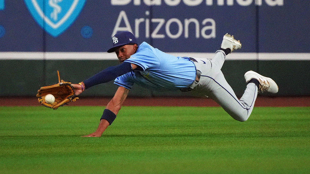 Tampa Bay Rays centerfielder Chandler Simpson (14) dives for the ball against the Arizona Diamondbacks during the fourth inning at Chase Field.